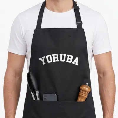 Yoruba collegiate aprons - White YORUBA text in an arched collegiate font style — shown on a black cotton canvas apron against a white background