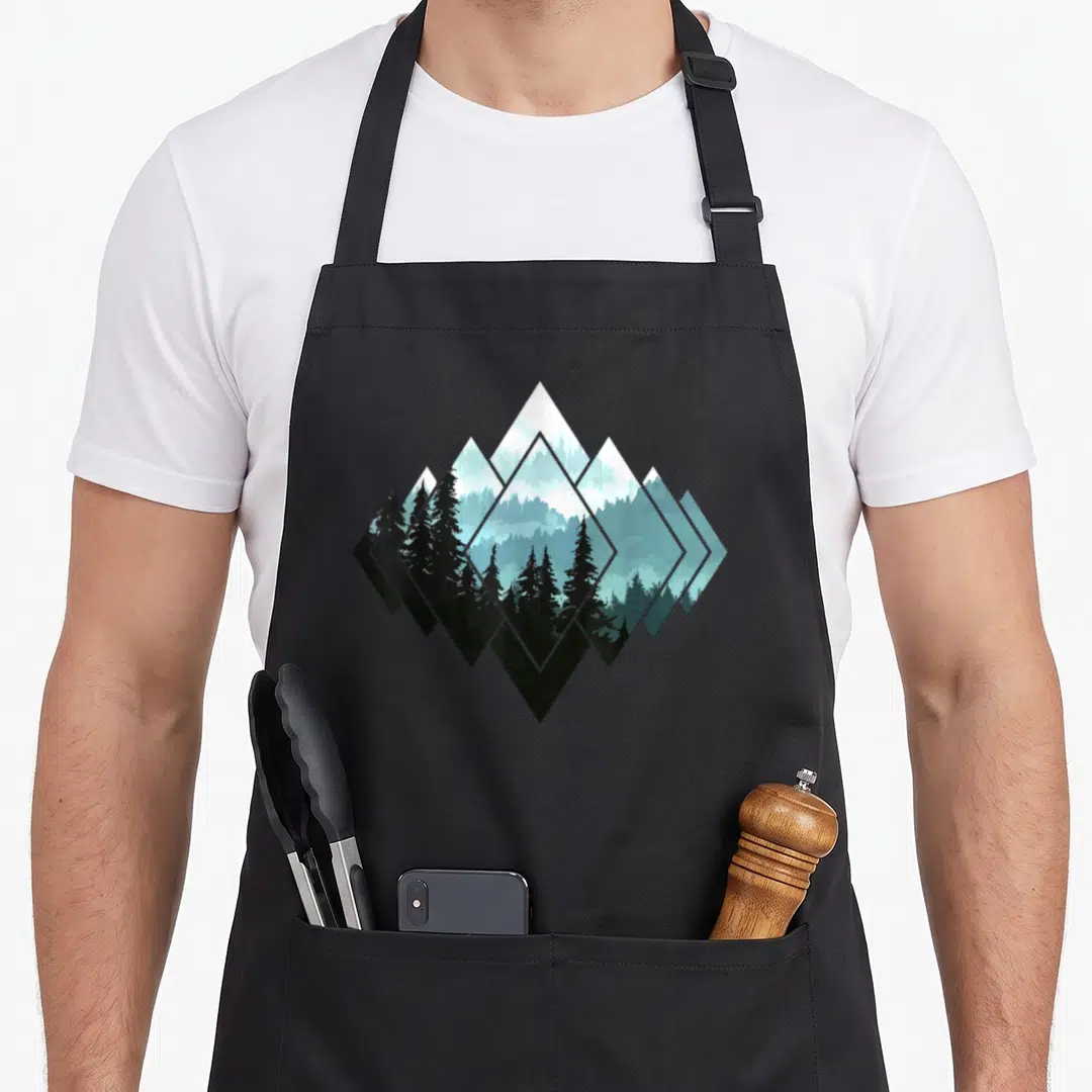 Trekking camping apron - Geometric diamond mountain forest landscape in black white teal blue minimalist art — shown on a black cotton canvas apron against a white background