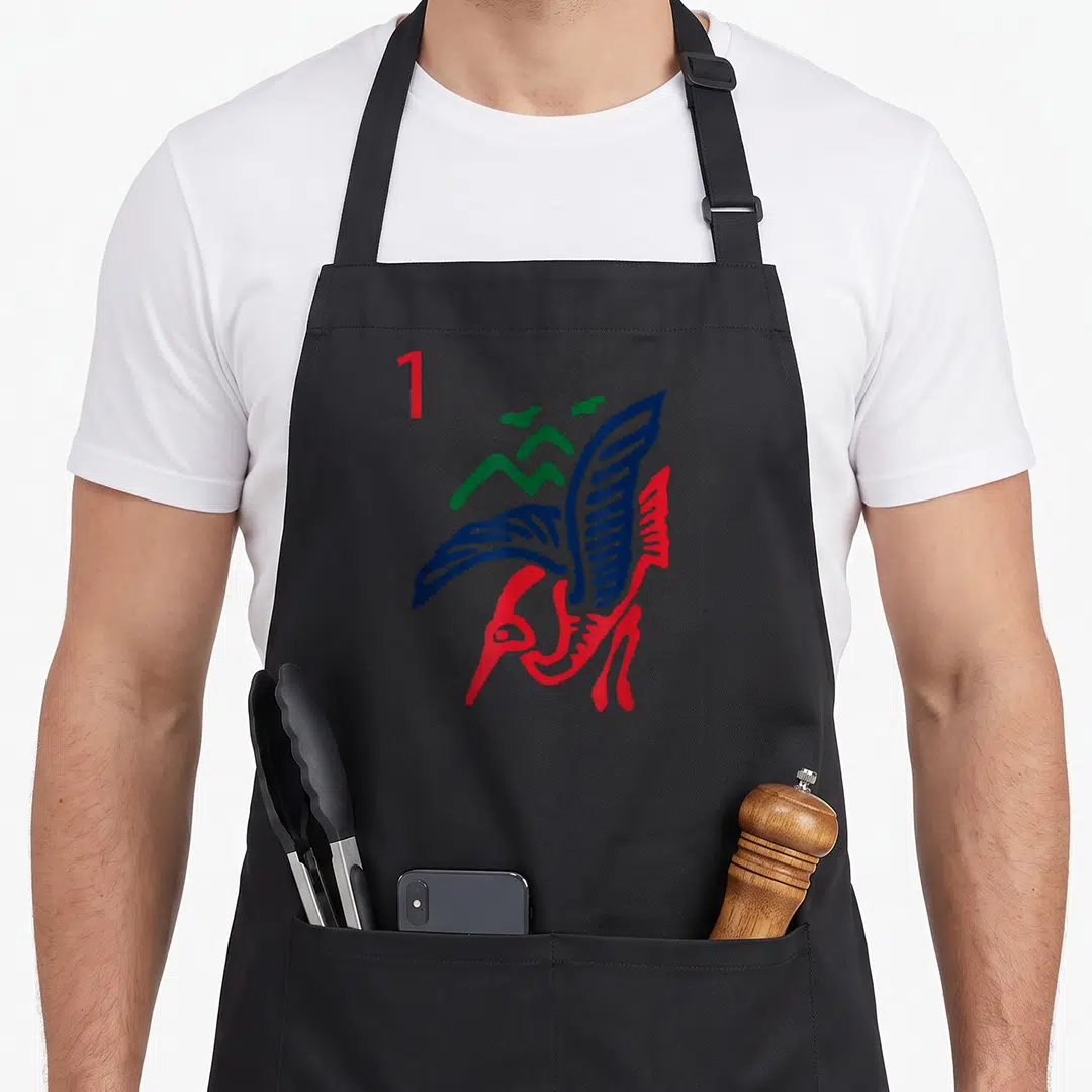 Bamboo mahjong apron - One tile bird graphic in red blue green line art with number one — shown on a black cotton canvas apron against a white background