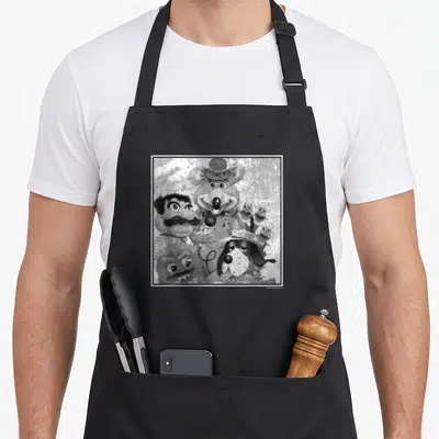 Shot e.a apron - Grey white black mouse wearing hat with text ZA TIME THE surrounded by chef dog and puppets — shown on a black cotton canvas apron against a white background