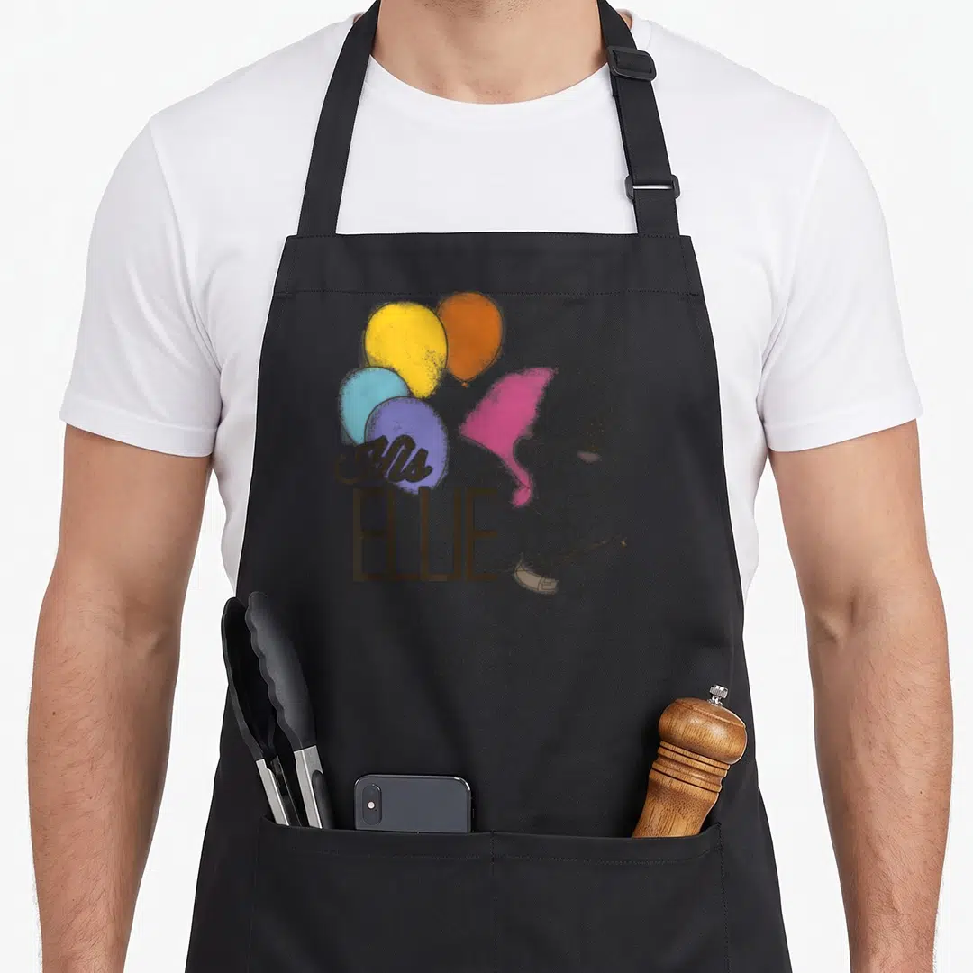 His balloon apron - Cartoon girl with pink hair holding four balloons with text His ELLIE overlaid — shown on a black cotton canvas apron against a white background