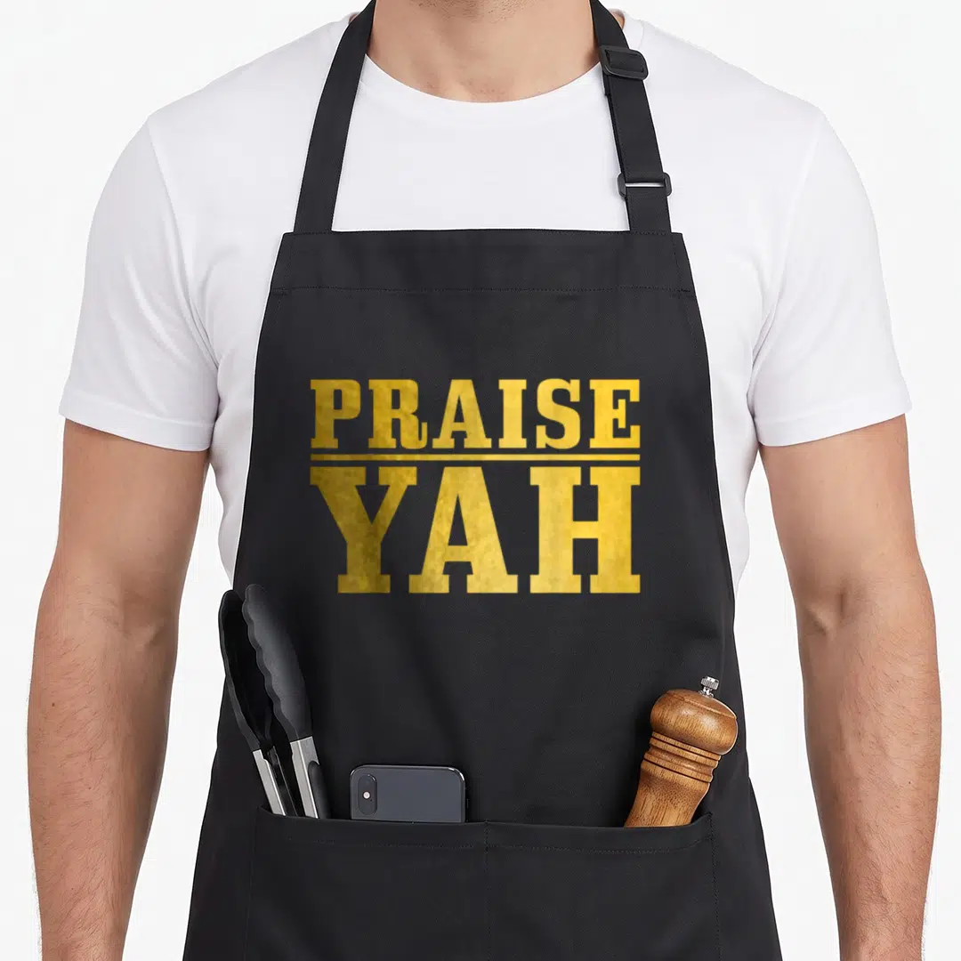 Praise jewish apron - Gold PRAISE YAH stacked typography separated by thin horizontal line on black background — shown on a black cotton canvas apron against a white background
