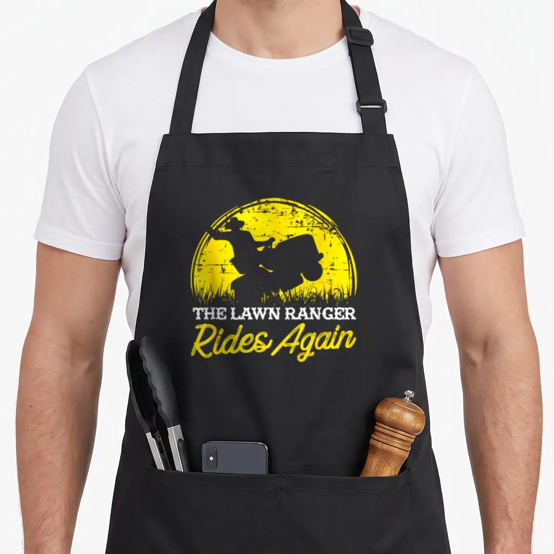 Garden mower apron - Grey rider silhouette on yellow sun with The Lawn Ranger Rides Again text — shown on a black cotton canvas apron against a white background