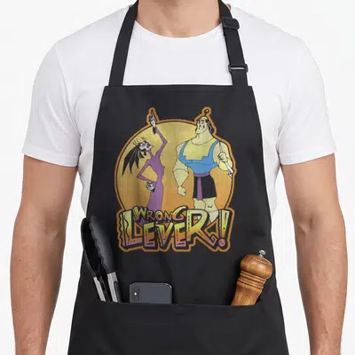 Esma kronk apron - Two characters standing before yellow circle with Wrong Lever text overlay in distressed style — shown on a black cotton canvas apron against a white background