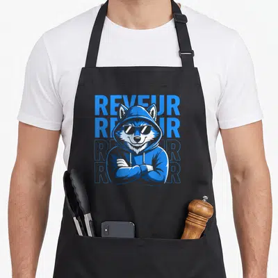 Reveur robin lover apron - Blue hooded wolf wearing sunglasses with four stacked Reveur text in cartoon style — shown on a black cotton canvas apron against a white background