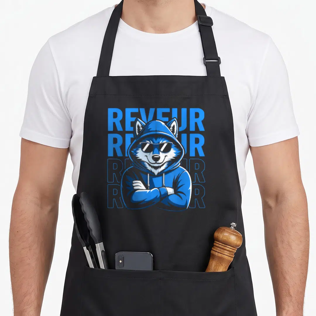 Reveur robin lover apron - Blue hooded wolf wearing sunglasses with four stacked Reveur text in cartoon style — shown on a black cotton canvas apron against a white background