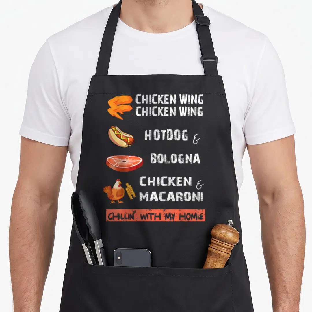 Wing chicken apron - Cartoon chicken wing, hotdog, bologna, and chicken with macaroni next to white lyrics — shown on a black cotton canvas apron against a white background