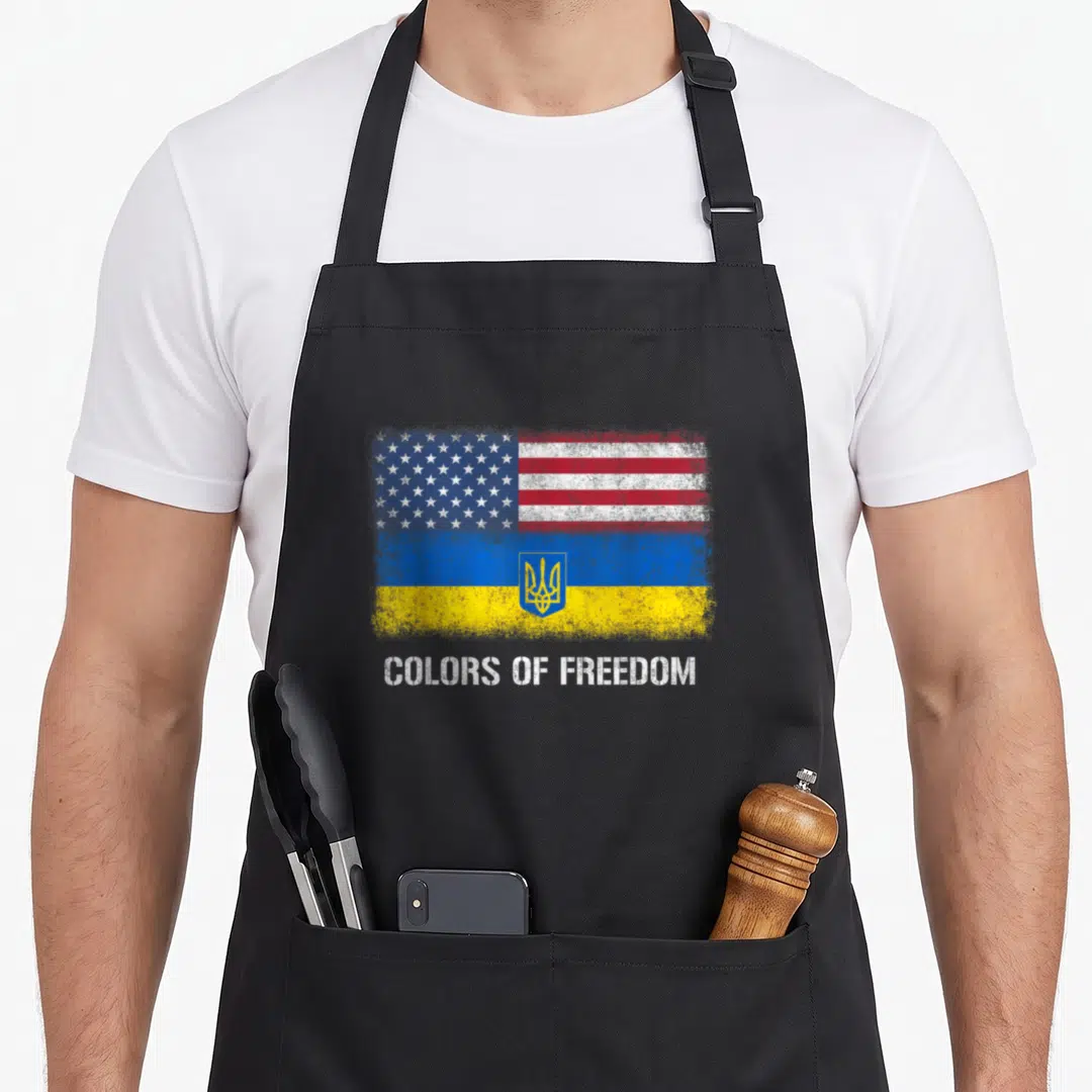 Vintage ukrainian american flag apron - Distressed combined US and Ukrainian flag with COLORS OF FREEDOM text below — shown on a black cotton canvas apron against a white background