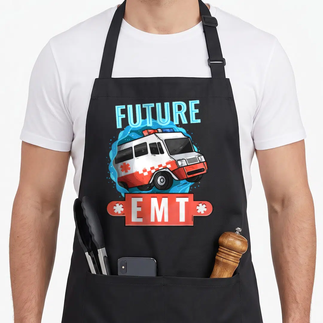 Emt future emergency apron - Cartoon ambulance with FUTURE EMT text on red banner and blue splash background — shown on a black cotton canvas apron against a white background
