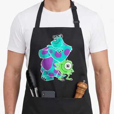 Monster university apron - Sulley and Mike Wazowski cartoon in turquoise purple and lime green — shown on a black cotton canvas apron against a white background