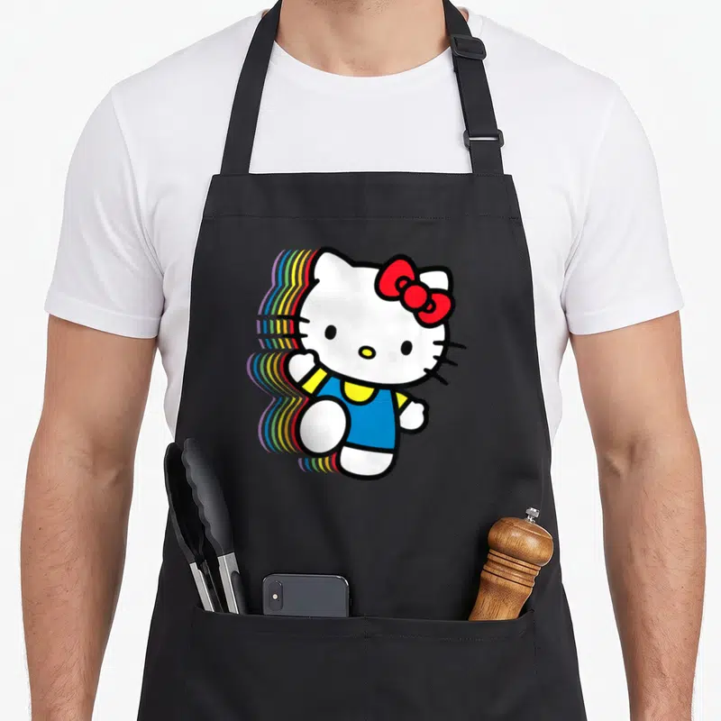 Funny rainbow apron - Cartoon cat with red bow blue shirt rainbow shadow trail left — shown on a black cotton canvas apron against a white background