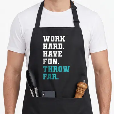 Javelin track apron - Stacked white and teal text reading WORK HARD HAVE FUN THROW FAR — shown on a black cotton canvas apron against a white background