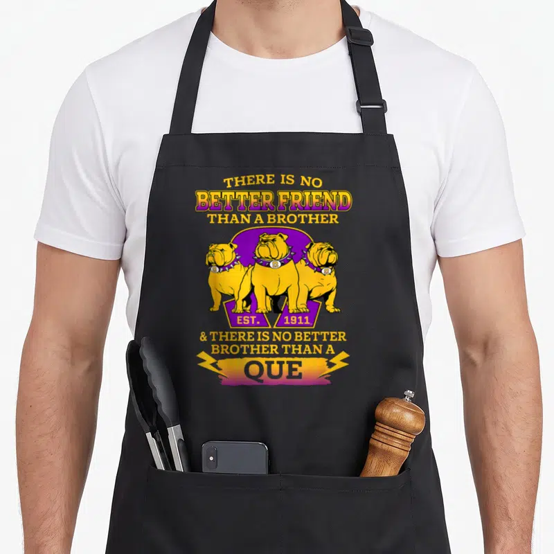 Psi pride apron - Three yellow bulldogs with spiked collars and purple background with established 1911 text — shown on a black cotton canvas apron against a white background
