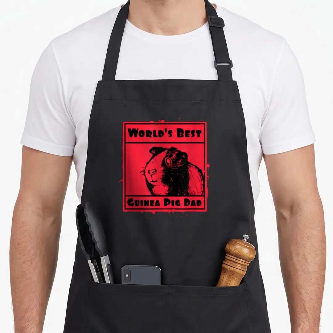 Vintage pig guinea dad apron - Red frame with black guinea pig illustration and text reading World's Best Guinea Pig Dad — shown on a black cotton canvas apron against a white background