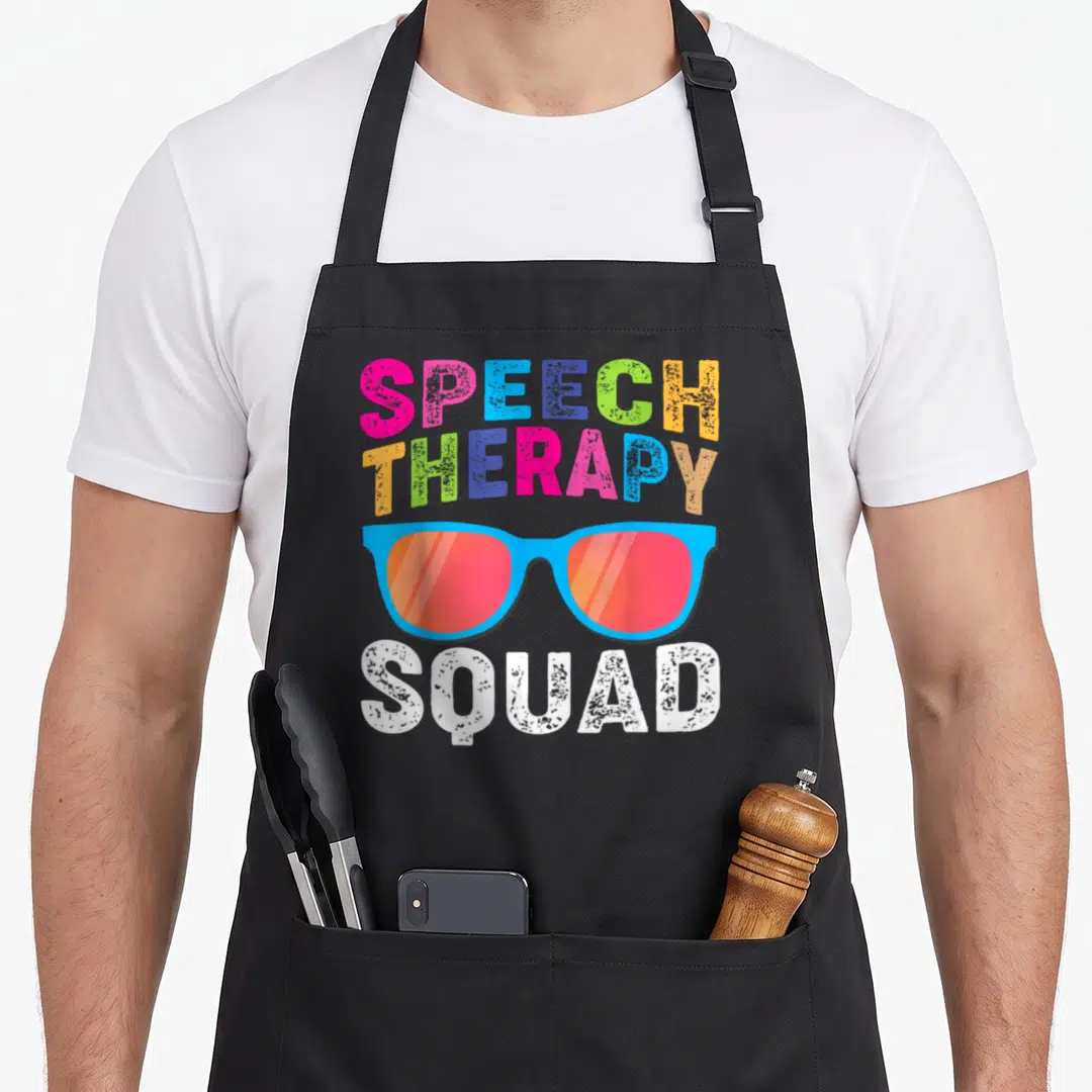 Squad my therapy apron - Colorful sunglasses with stacked speech therapy squad text in pink blue green orange and white — shown on a black cotton canvas apron against a white background