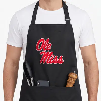 Mississippi icon officially apron - Red script text reading Ole Miss stacked vertically with white outlines — shown on a black cotton canvas apron against a white background
