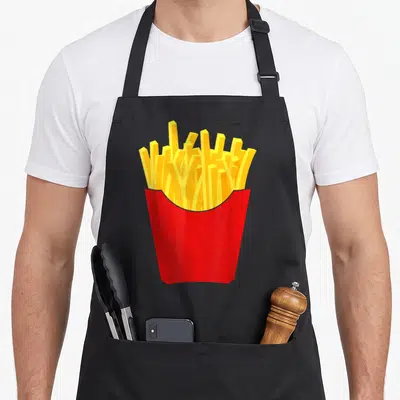 Costume french apron - Red container holding yellow french fries centered on black fabric — shown on a black cotton canvas apron against a white background