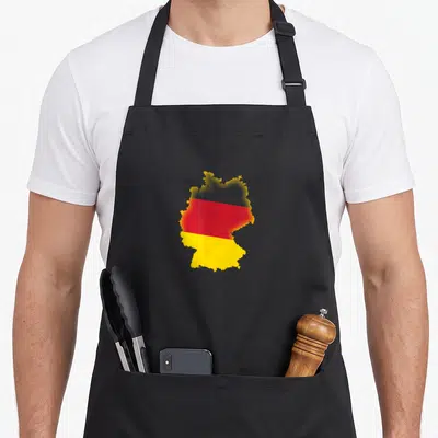 Fill german apron - Map of Germany silhouette filled with black red and yellow flag colors — shown on a black cotton canvas apron against a white background