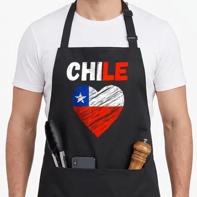 Chile holiday apron - Distressed heart filled with white red and blue flag colors below printed word CHILE — shown on a black cotton canvas apron against a white background