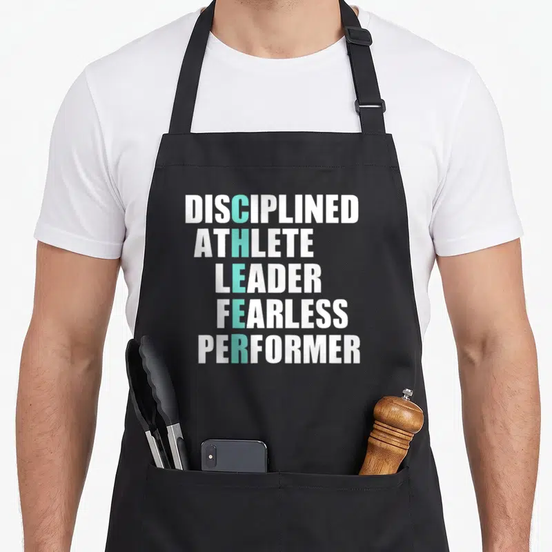 Cheerleader cheer apron - Stacked white text with teal CHEER acronym spelling out Disciplined Athlete Leader Fearless — shown on a black cotton canvas apron against a white background