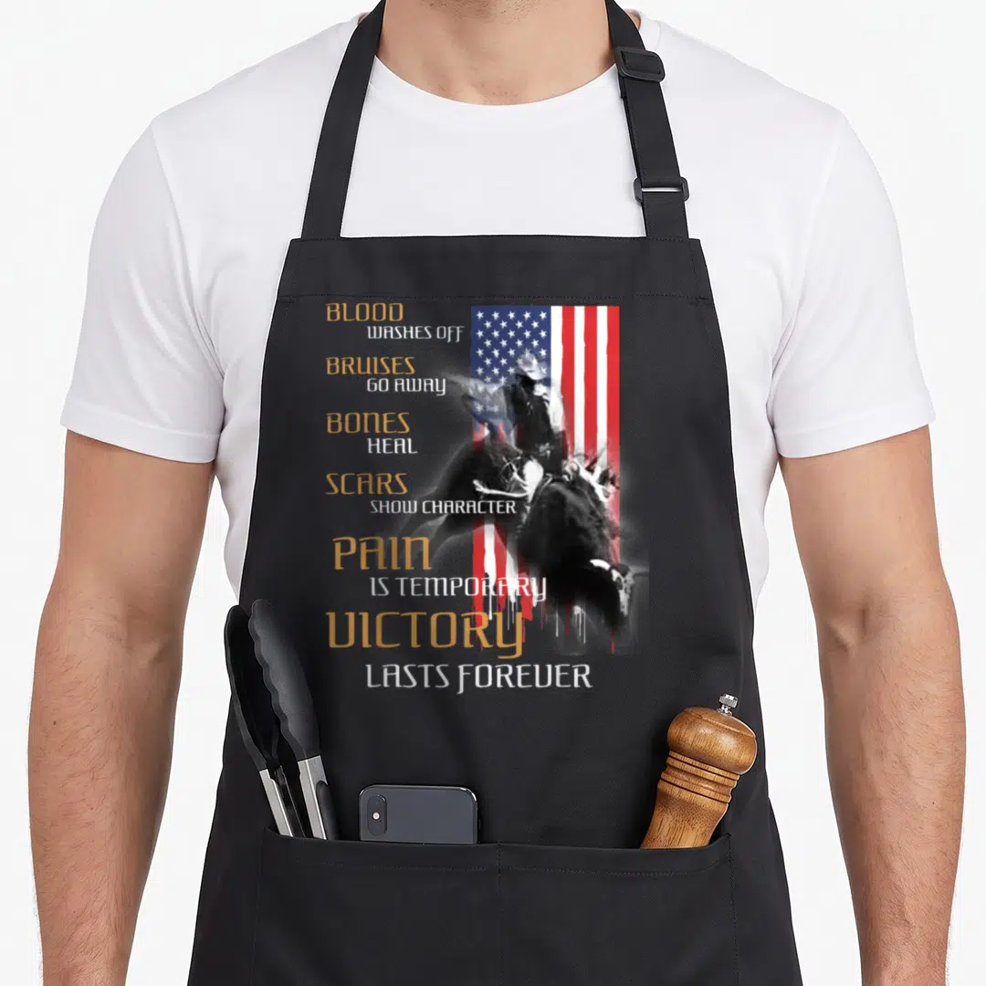 Texas western apron - Stacked gold and white text next to a distressed bull rider silhouette over a dripping American — shown on a black cotton canvas apron against a white background