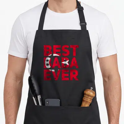 Baba turkish apron - Red and white distressed text reading BEST BABA EVER with crescent and star embedded in letters — shown on a black cotton canvas apron against a white background