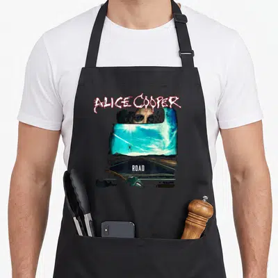 Vintage trip road apron - Alice Cooper eyes in car mirror above blue road with red spider and white text — shown on a black cotton canvas apron against a white background