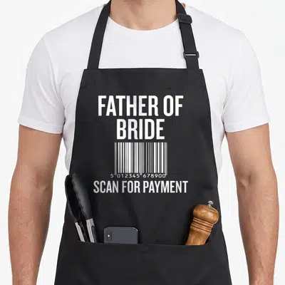 Scan bride apron - White barcode with stacked text reading FATHER OF BRIDE and SCAN FOR PAYMENT — shown on a black cotton canvas apron against a white background