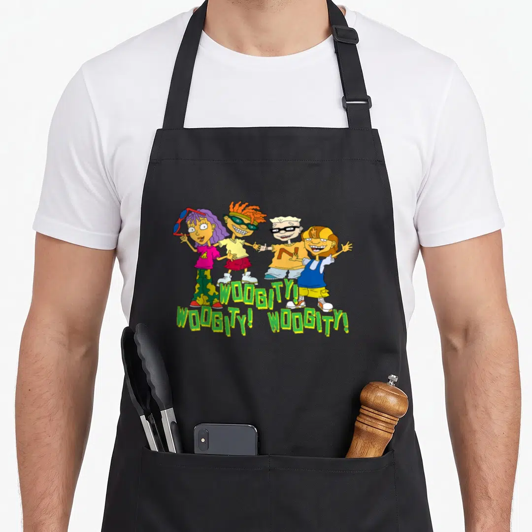 Power character aprons - Four cartoon children standing above three instances of the word WOOGITY in green and yellow — shown on a black cotton canvas apron against a white background