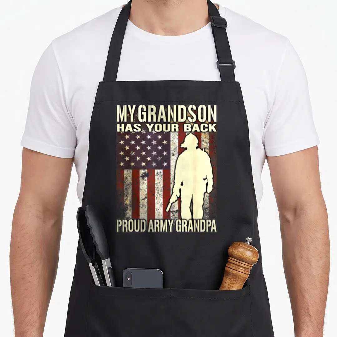 Grandson flag grandpa apron - Soldier silhouette on distressed flag with My Grandson Has Your Back text — shown on a black cotton canvas apron against a white background