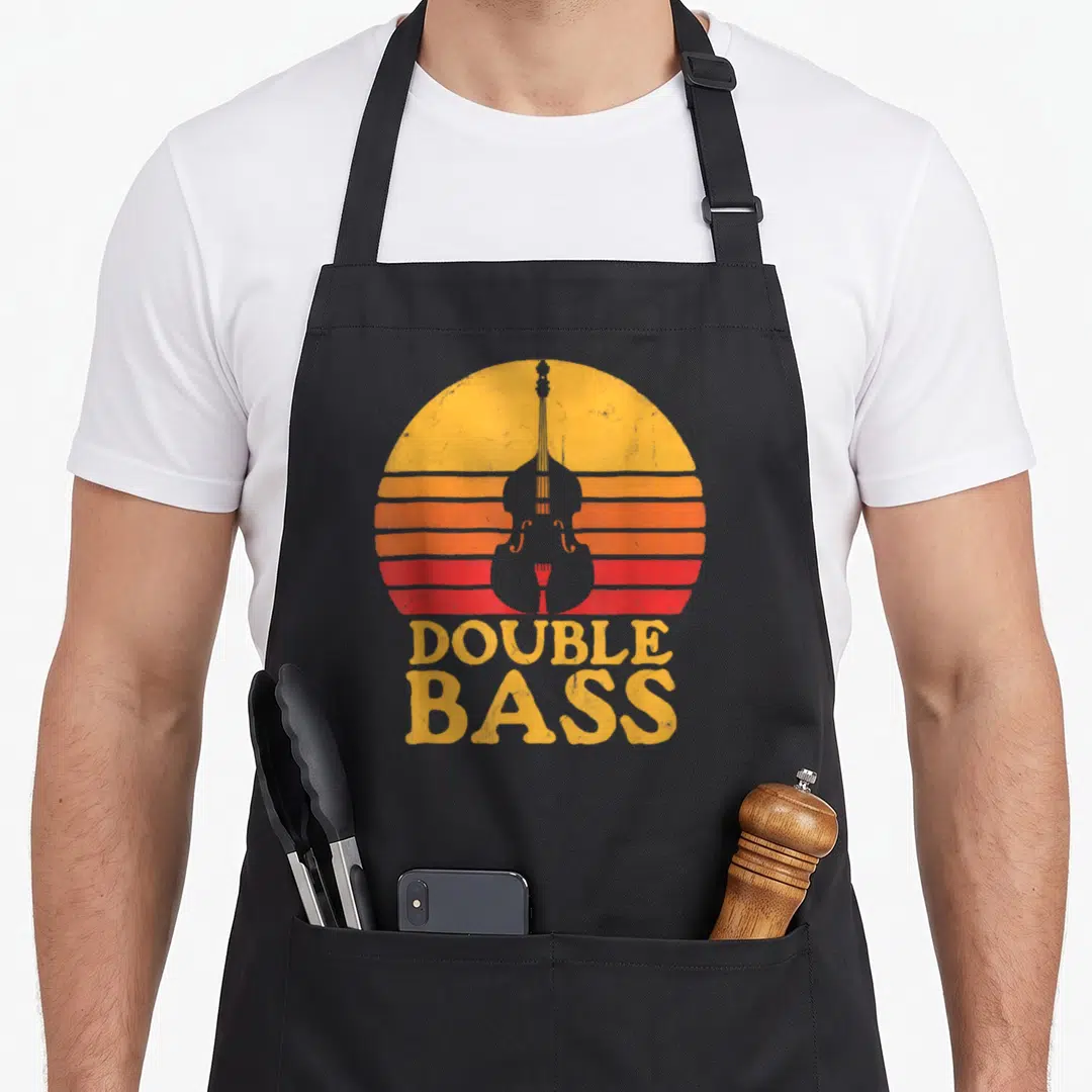 Bass player double apron - Grey double bass silhouette on yellow orange red striped sun with stacked DOUBLE BASS text — shown on a black cotton canvas apron against a white background