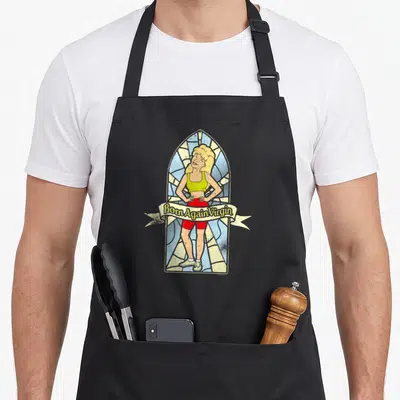 King stained apron - Cartoon woman in stained glass with Born Again Virgin banner text in blue yellow red lime green — shown on a black cotton canvas apron against a white background