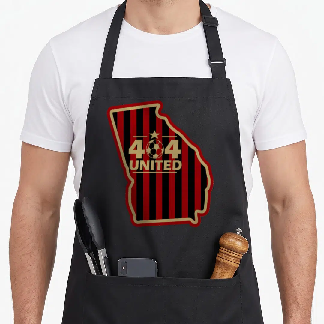 Soccer atlanta apron - Georgia map outline filled with red and black stripes containing 404 UNITED text and soccer ball — shown on a black cotton canvas apron against a white background