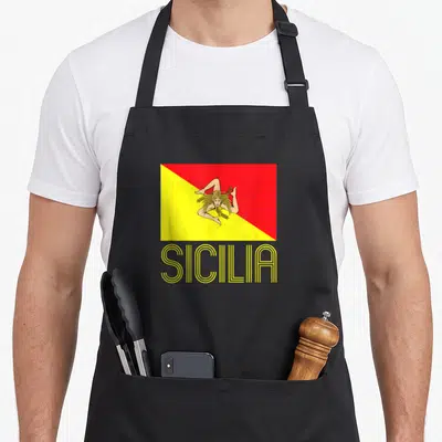 Flag sicilian apron - Red and yellow Sicily flag with linear SICILIA text below — shown on a black cotton canvas apron against a white background