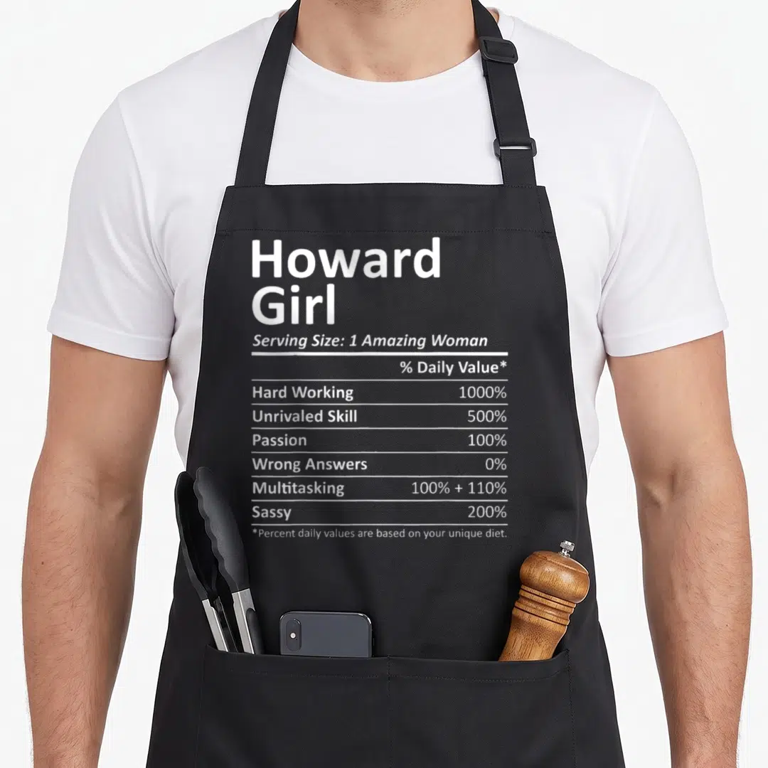 Howard wisconsin apron - White typography mimicking a nutrition label listing traits like hard working sassy — shown on a black cotton canvas apron against a white background