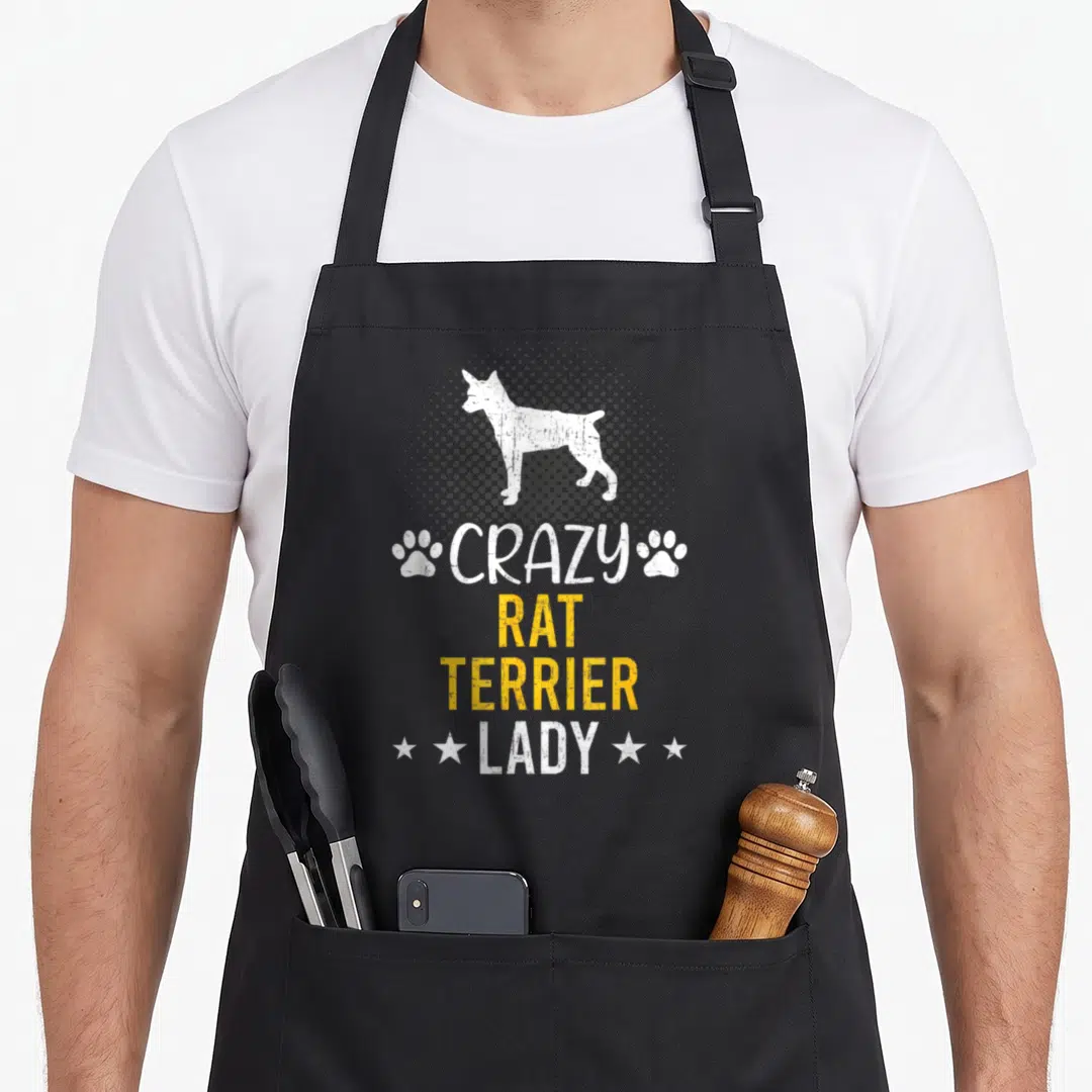 Funny rat dog apron - White dog silhouette on grey halftone circle with CRAZY RAT TERRIER LADY text and paw prints — shown on a black cotton canvas apron against a white background