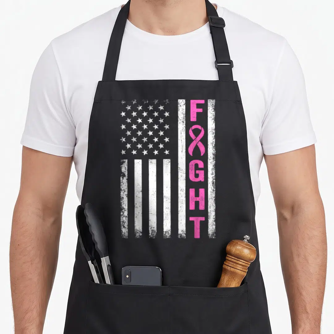 Survivor breast cancer awareness aprons - Distressed white USA flag next to vertical pink FIGHT text with ribbon — shown on a black cotton canvas apron against a white background
