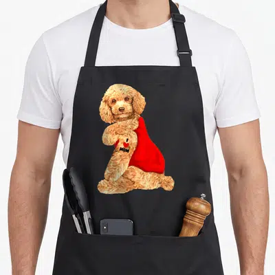 Poodle tattoo dog apron - Tan poodle sitting in red dress with I heart MOM text — shown on a black cotton canvas apron against a white background