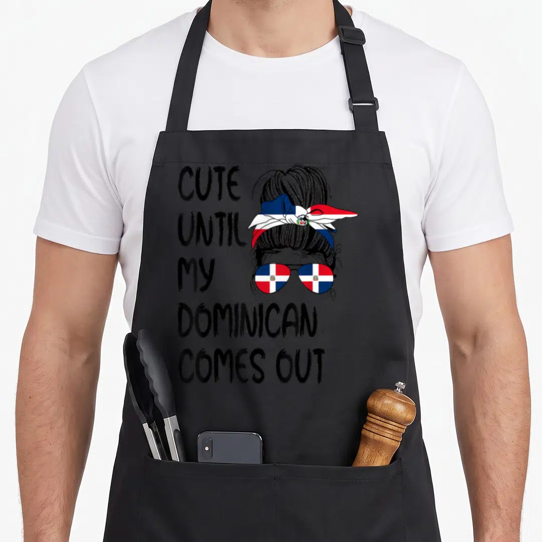 Come dominican apron - Cartoon woman with messy bun, flag headband, and sunglasses next to stacked text — shown on a black cotton canvas apron against a white background