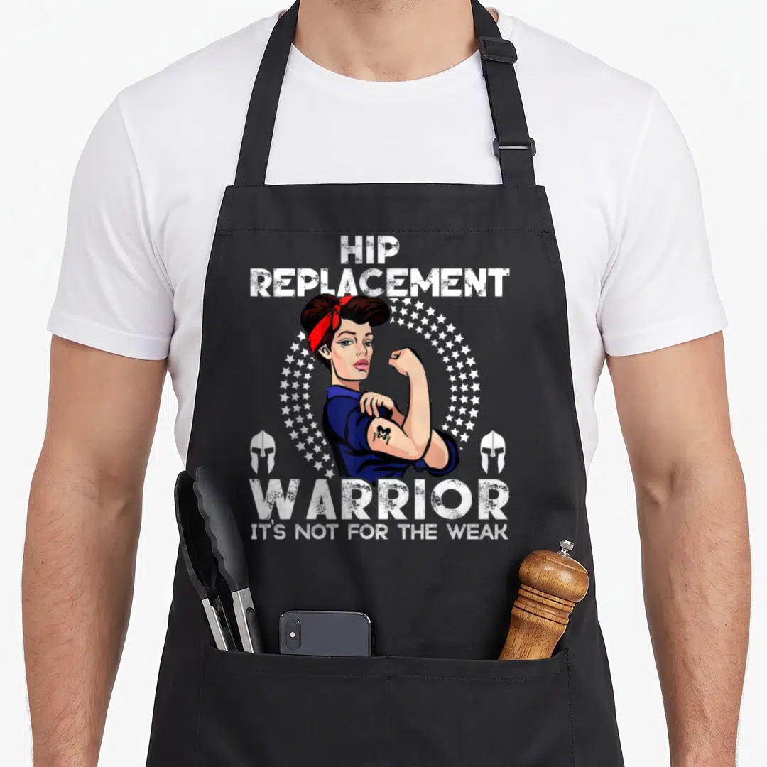 Warrior hip apron - Retro woman flexing arm surrounded by stars with helmets and text — shown on a black cotton canvas apron against a white background