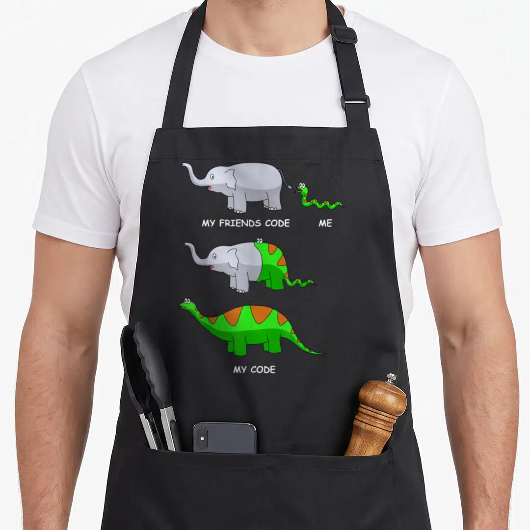 Developer coder engineer apron - Elephant and snake merge into green dinosaur with orange spots under text labels — shown on a black cotton canvas apron against a white background