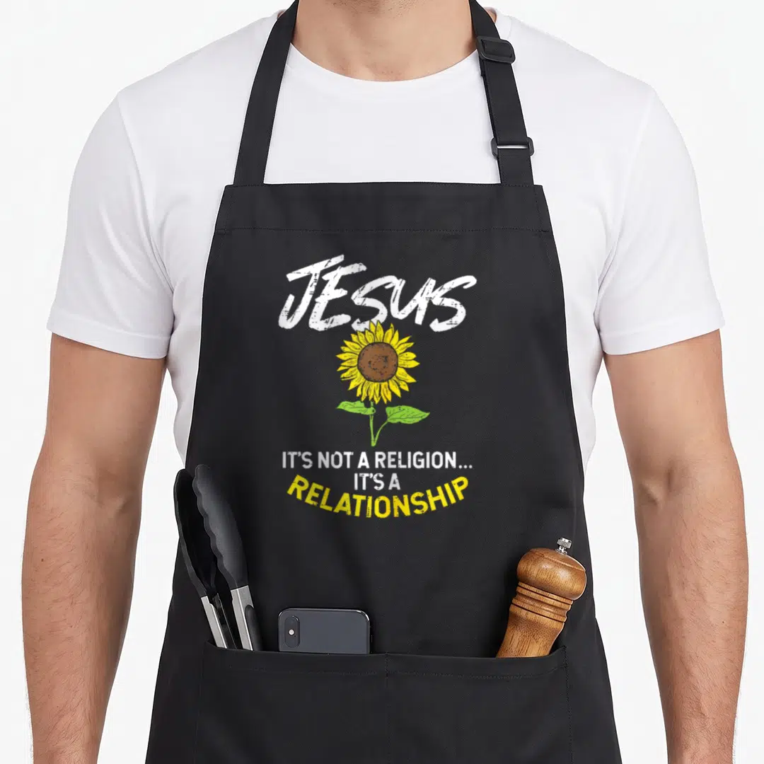 Boredkoalas sunflower apron - JESUS text above yellow sunflower with three line statement below — shown on a black cotton canvas apron against a white background