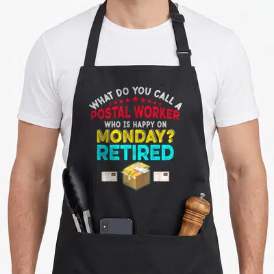 Postal retired retirement apron - Typographic pun with stars, brown box, and envelopes in red yellow cyan white — shown on a black cotton canvas apron against a white background