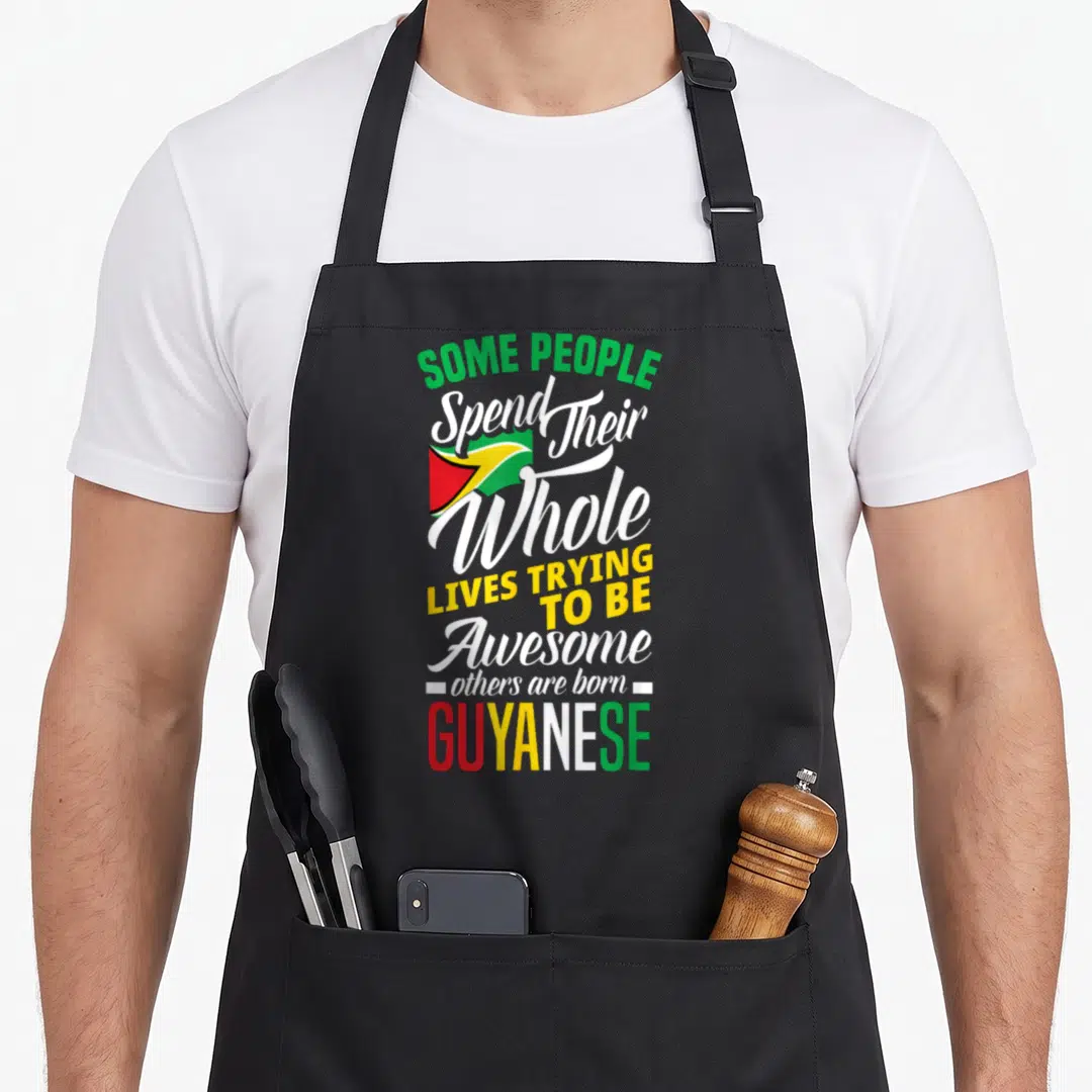 Cute guyanese guyana apron - Stacked text reading born GUYANESE with small flag in green yellow red and white — shown on a black cotton canvas apron against a white background