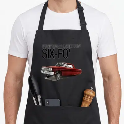 Cruisin lowrider girl apron - Red classic car illustration below stacked black text reading CRUISIN DOWN THE STREET — shown on a black cotton canvas apron against a white background