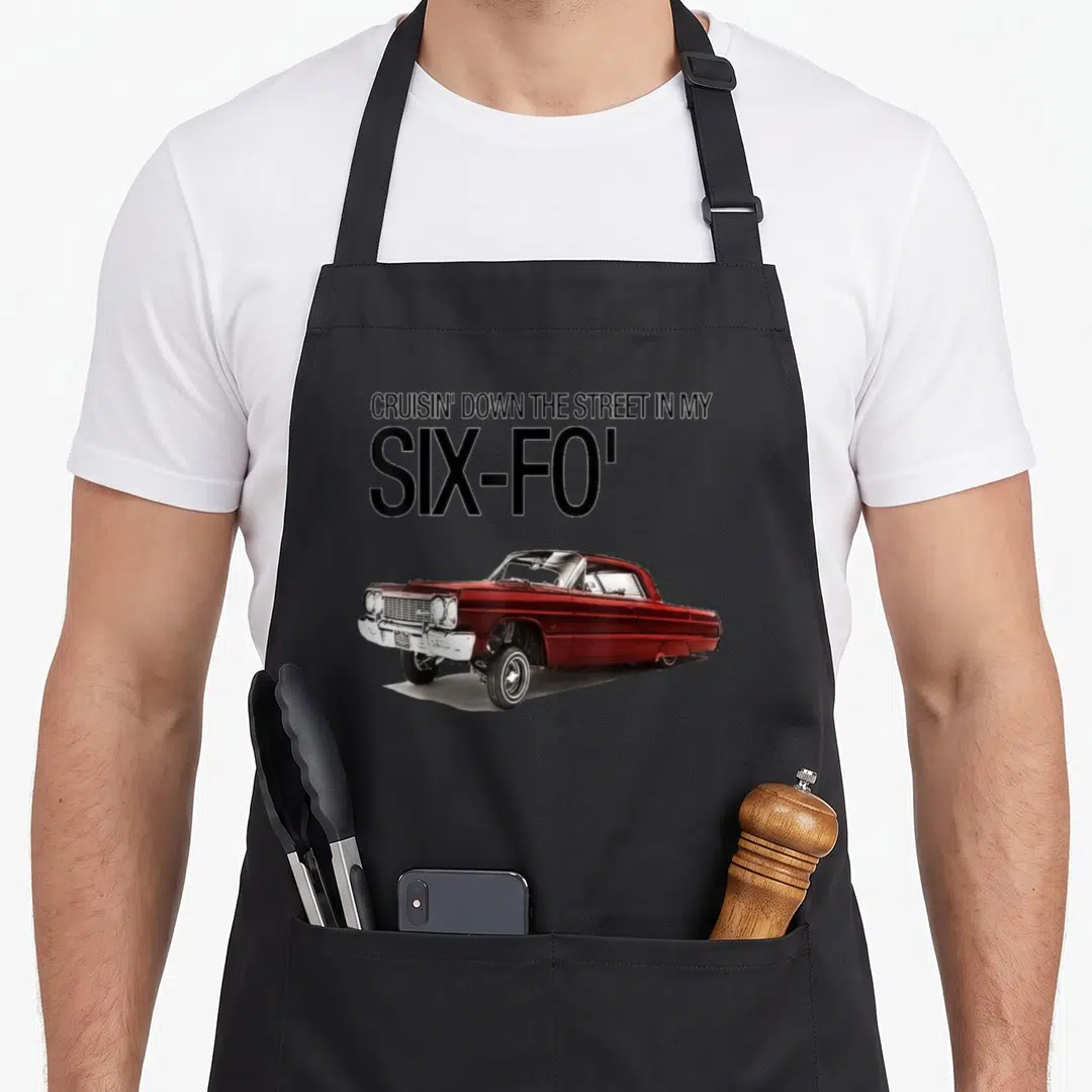 Cruisin lowrider girl apron - Red classic car illustration below stacked black text reading CRUISIN DOWN THE STREET — shown on a black cotton canvas apron against a white background