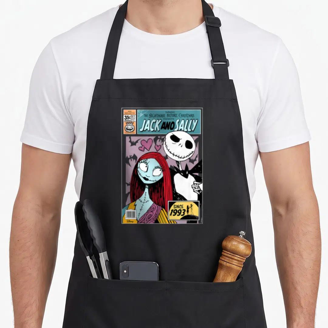 Cute jack christmas apron - Jack Skellington and Sally comic cover art with hearts and price tag in white black red — shown on a black cotton canvas apron against a white background