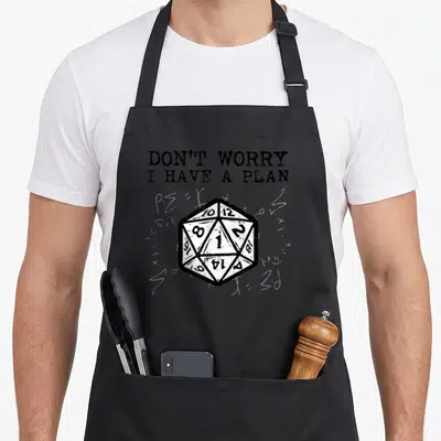 Rpg plan apron - Distressed twenty-sided die and text DON'T WORRY I HAVE A PLAN on grey background — shown on a black cotton canvas apron against a white background