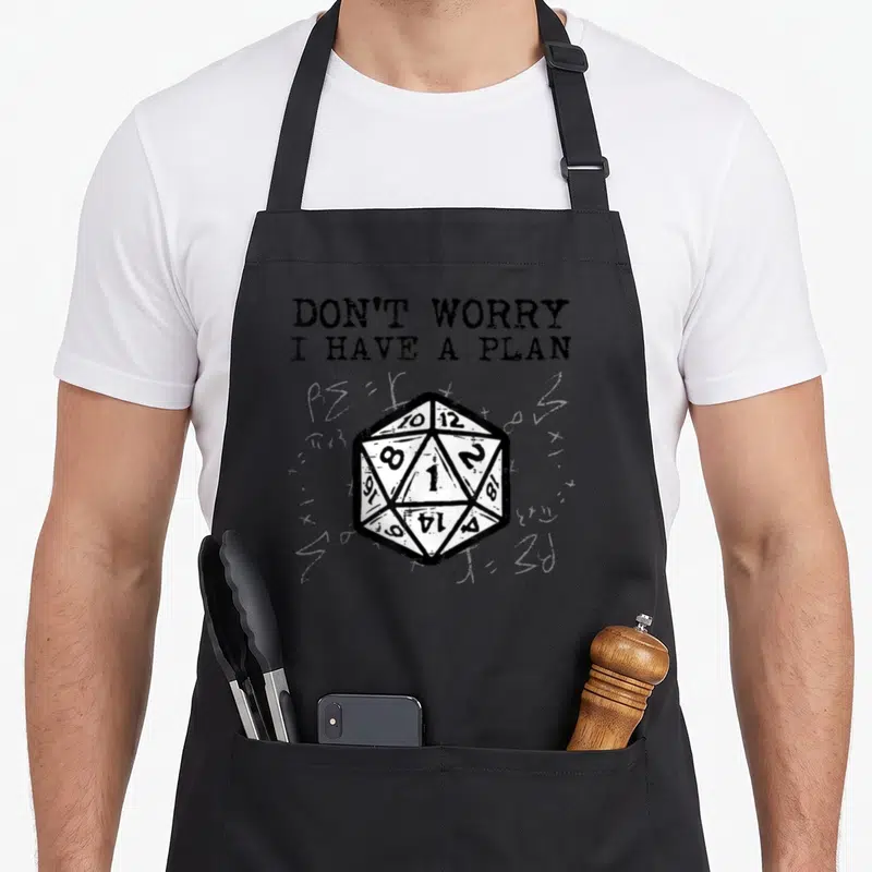 Rpg plan apron - Distressed twenty-sided die and text DON'T WORRY I HAVE A PLAN on grey background — shown on a black cotton canvas apron against a white background
