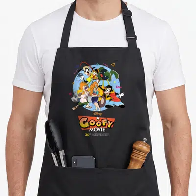 Movie road apron - Goofy and friends in light blue circle with A Goofy Movie 30th Anniversary text and geometric shapes — shown on a black cotton canvas apron against a white background